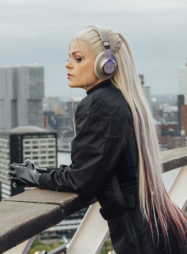 Davina Michelle wearing headphones looking out from the Euromast